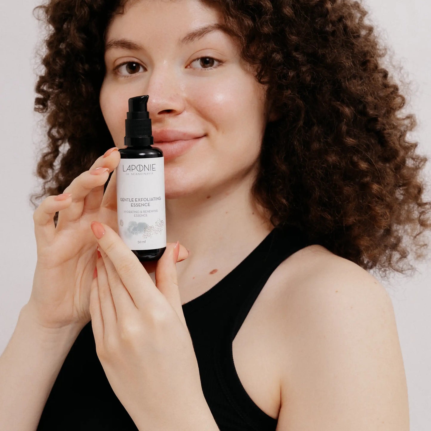 Laponie Gentle Exfoliating Essence held by model