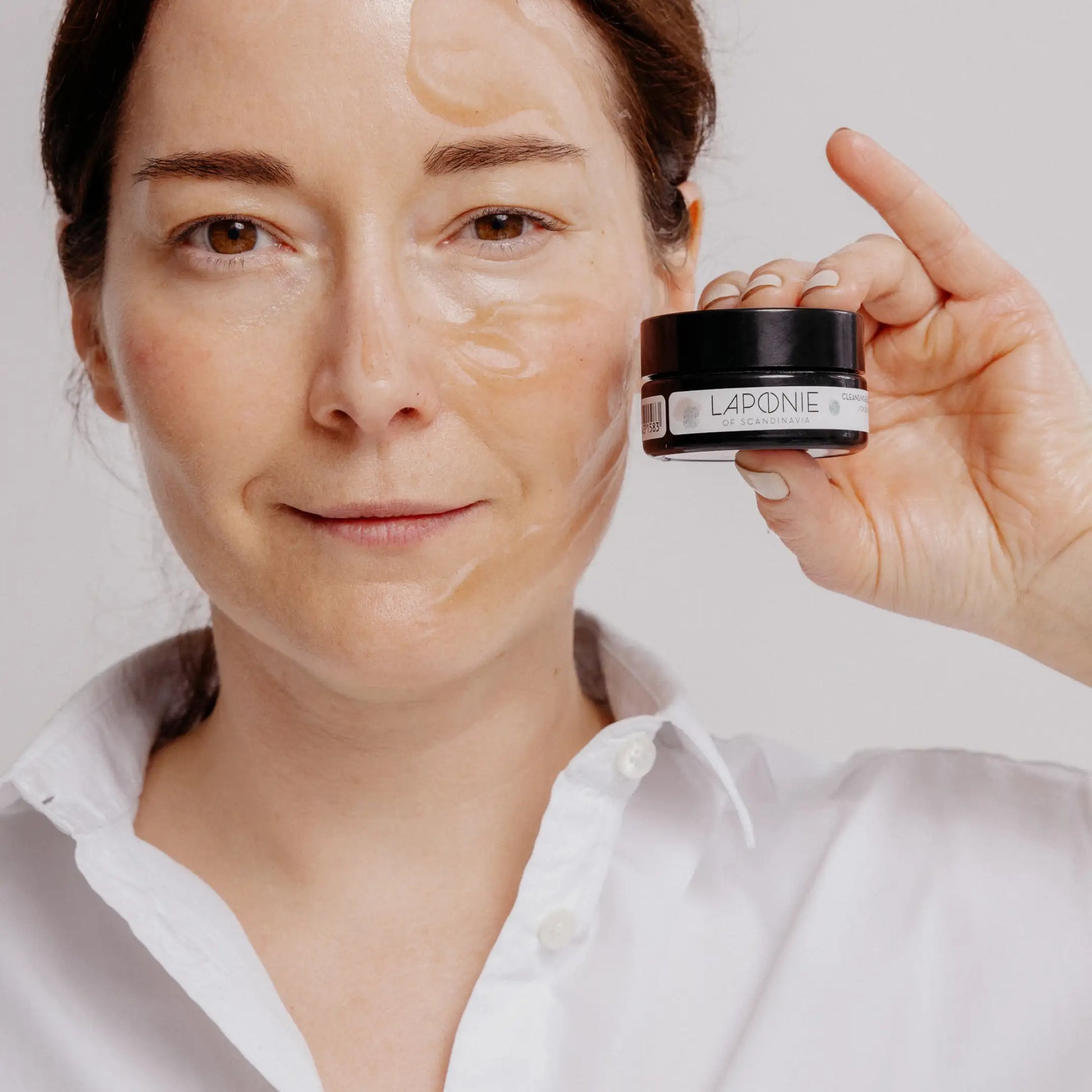 Laponie Cleansing and Balancing Face Mask on face of model posing with the product package